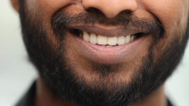 mouth man with unshaven facial hair stubble and serious expression close up
