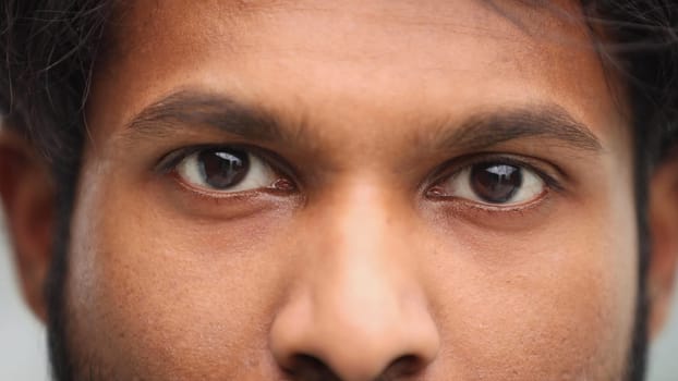 eyes of a smiling hispanic man, close-up eyes macro