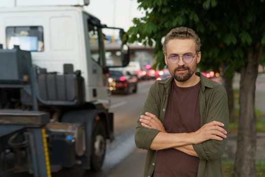 Depressed man with crossed hands against backdrop of truck, symbolizing concept of illegal parking. Truck background represents consequences and potential enforcement of parking violations. High quality photo