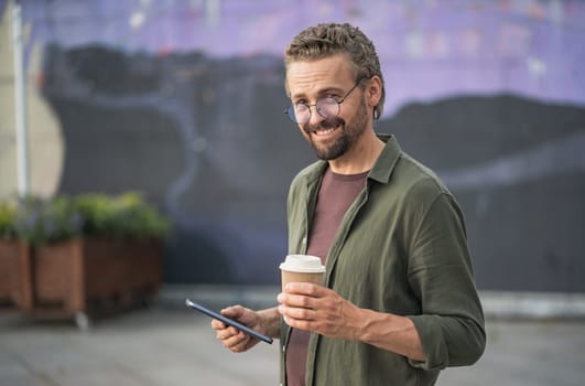 Sarcastic man typing a message on his phone while enjoying a cup of coffee outdoors. With a hint of irony and sarcasm in his expression, he combines technology and leisure in a playful manner. High quality photo