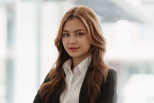 Portrait of young happy woman and confident business at office.