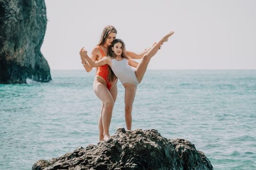 Silhouette mother and daughter doing yoga at beach. Woman on yoga mat in beach meditation, mental health training or mind wellness by ocean, sea