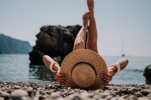 Woman travel sea. Happy tourist taking picture outdoors for memories. Woman traveler looks at the edge of the cliff on the sea bay of mountains, sharing travel adventure journey.