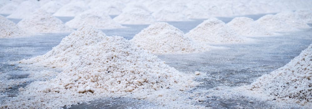 Sea salt farm. Pile of brine salt. Raw material of salt industrial. Sodium Chloride mineral. Evaporation and crystallization of sea water. White salt harvesting. Agriculture industry. Traditional farm