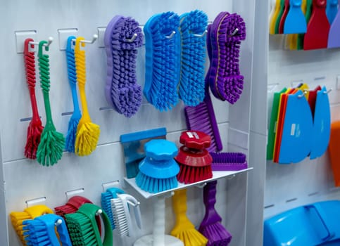 Brushes hang on shelf. Dish wash brush, professional double wing scrub, round scrub for food processing and manufacturing. Cleaning tool for food safety in food industry. Durable cleaning brush.