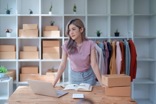 Portrait Of Asian Female Owner Of Fashion Store Clothing Store successful happy smile at small business, sme or ecommerce concepts.