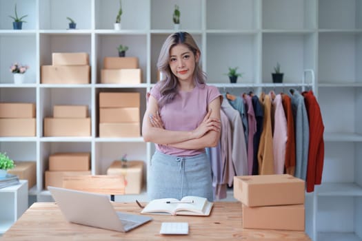 Portrait Of Asian Female Owner Of Fashion Store Clothing Store successful happy smile at small business, sme or ecommerce concepts.