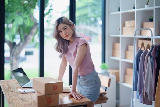 Portrait Of Asian Female Owner Of Fashion Store Clothing Store successful happy smile at small business, sme or ecommerce concepts.