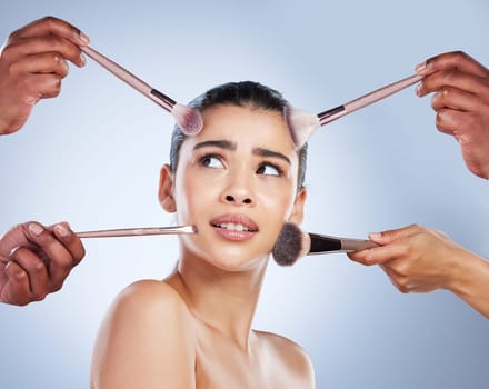 Brush, makeup and confused face of woman in studio for wellness, beauty and cosmetics on blue background. Cosmetology, skincare and girl with brushes for cosmetic application, foundation and products.