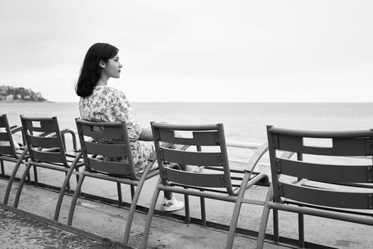 Beautiful smiling young mixed race woman at the Promenade des Anglais in Nice, France