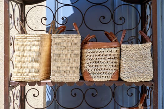 Traditional straw bags with leather parts on sale in Nice, France
