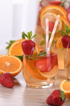 Summer Sangria cocktail or lemonade with strawberry, orange and mint. Refreshing organic non-alcoholic, Detox vitaminized healthy drink, fruit in a glass