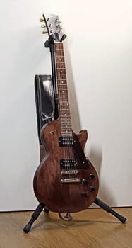 Itterbeck, Germany - June 28 2023 A dark brown solid body electric guitar on a guitar stand. It's a Gibson Les Paul