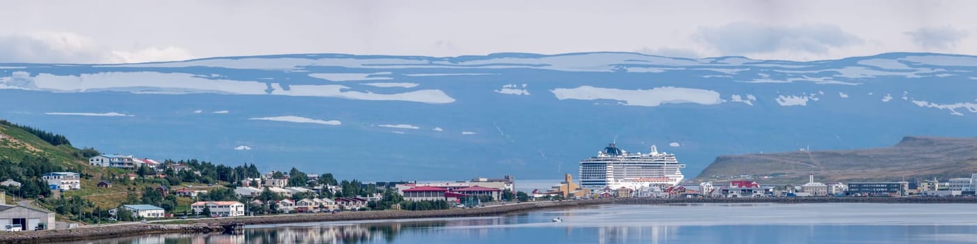 Akureyri Iceland town cintyscape, scenic view on urban port harbour. Cruise ship docked in port of the small town of Akureyri in northern Iceland. Eyjafjordur fjord.