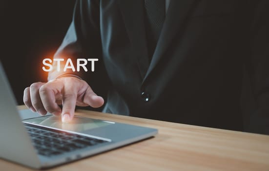 Businessman pressing his finger to start a business. Startup concept. Business concept.