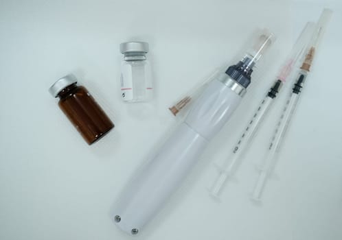 Equipment after microneedling procedure. Syringes. Serum bottle. Dermapen device. Microneedling device