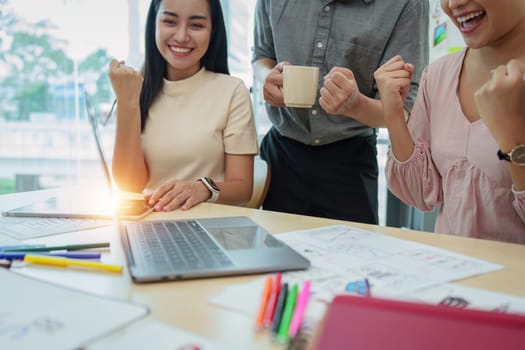 Diverse business team celebrate and collaboration and analyze financial data for long term investments.