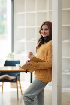 Beautiful young Asian woman college student at classroom. College student working on the college campus. back to school concept.