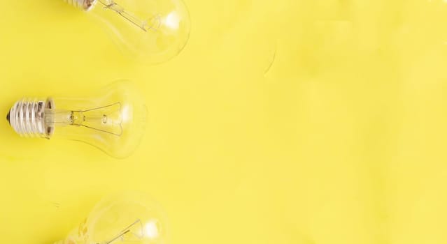 incandescent lamps on yellow background, copyspace