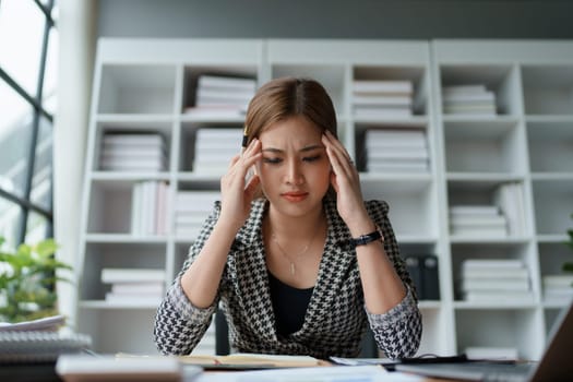 Portrait of business owner, woman using computer and financial statements Anxious expression on expanding the market to increase the ability to invest in business.