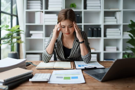 Portrait of business owner, woman using computer and financial statements Anxious expression on expanding the market to increase the ability to invest in business.