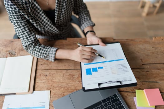 financial, Planning, Marketing and Accounting, portrait of Asian employee checking financial statements using documents and calculators at work..