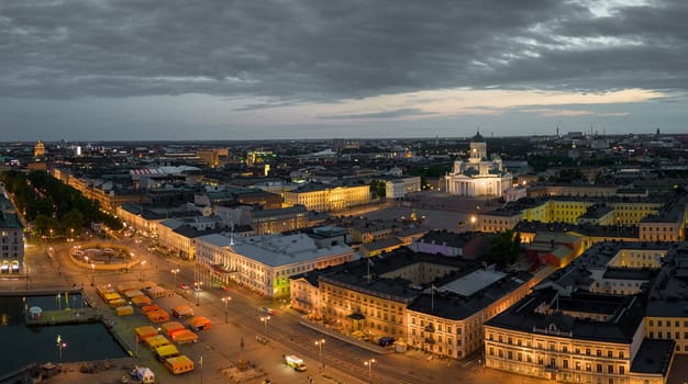 Helsinki Cathedral and Market Square by lit government buildings at dawn. High quality photo