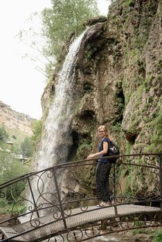 Beautiful nature. Travel. Freedom. Mountain waterfall surrounded with trees and fog