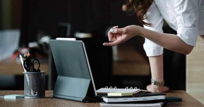 businesswoman working with laptop computer for marketing analysis report at her office.