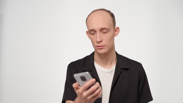 Bald man checking his smartphone with not happy face. Guy looking at smartphone hanging phone call he doesnt want to have conversation. FHD footage.
