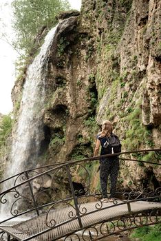 Beautiful nature. Travel. Freedom. Mountain waterfall surrounded with trees and fog