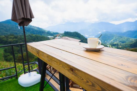 coffee on wood table at mountain view