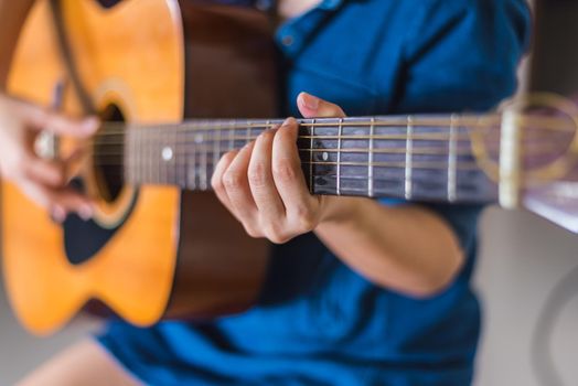 girl playing acoustic guitar isolate on white