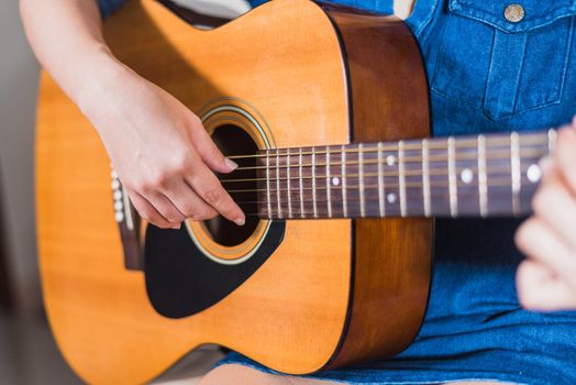 girl playing acoustic guitar isolate on white