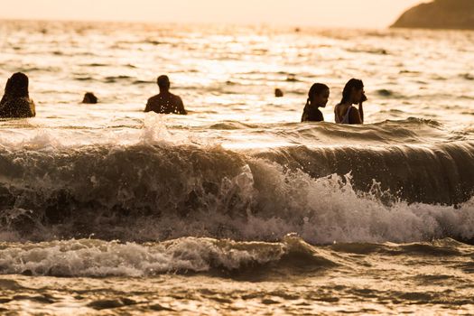 silhouette people wave sea beach sunset