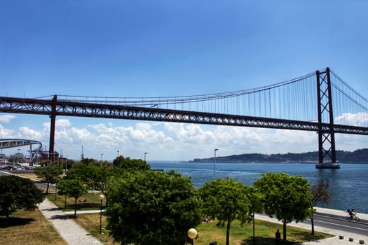 Lisbon, Portugal- 19 May, 2018: Banks of the Tagus River in Lisbon in Spring. 25th April bridge in the background