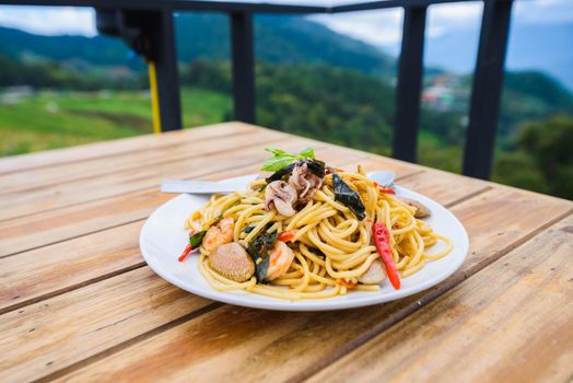 spagetti seafood spicy on wood table