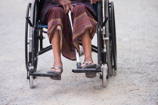 Close-up of legs of woman in a wheelchair