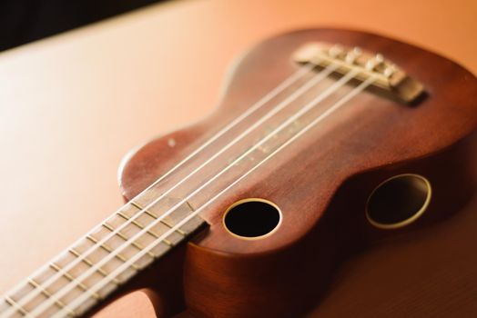 Vintage ukulele on wooden table