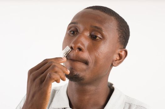 young man in casual on background going to shave mustache.