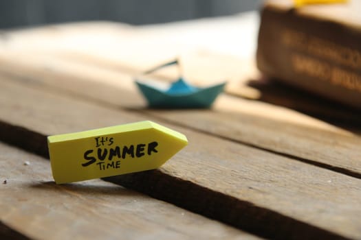 Its Summer time concept origami paper boat and tag.