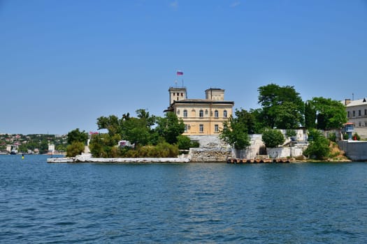 Sevastopol, Crimea - July 3, 2019. The building of Naval Hospital, founded in 1783 and monument to a destroyer Svobodny on Pavlovsky Cape