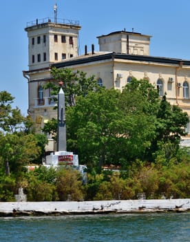 Sevastopol, Crimea - July 3, 2019. The building of Naval Hospital, founded in 1783 and monument to a destroyer Svobodny on Pavlovsky Cape