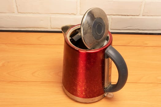 A broken old used electric kettle. Kitchen Accessories. High quality photo