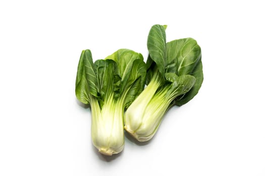 Isolated Fresh Organic Pak Choi, Bok Choy, a Chinese Cabbage, Raw Natural Healthy Vegetable Lying On White Background, Flat Lay, Top View. Asian Cuisine. Horizontal plane. High quality photo