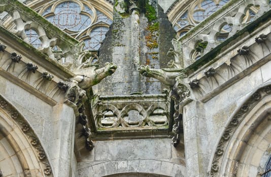 Two gargoyles on the walls of a cathedral of Saint Julien at Le mans, France
