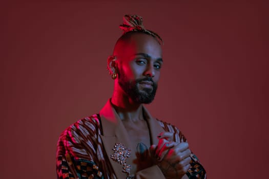 Retro wave or synth wave portrait young happy serious african-american man at studio. High Fashion male model in colorful bright neon lights posing.