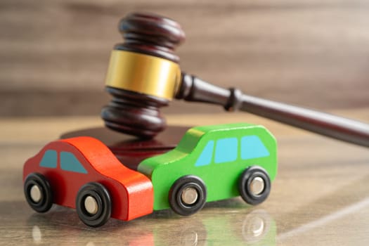 Hammer gavel judge with car vehicle accident, insurance coverage claim lawsuit court case.