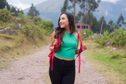 backpacker girl hiking on a vacation trip in nature summit. High quality photo