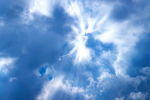 Sunbeam through the cloud on blue sky